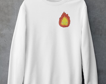 May include: White sweatshirt with a cartoon fire spirit design on the front. The fire spirit is yellow and orange with a smiling face.
