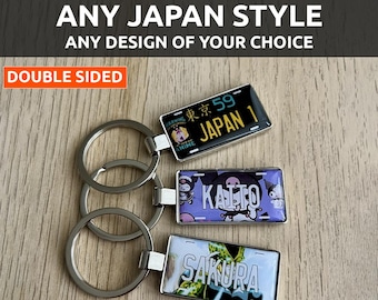 May include: Customizable keychains with Japanese license plate designs. The keychains feature various designs, including the text "JAPAN 1" and "SAKURA". The keychains are double-sided and have silver key rings. The text "FULLY CUSTOMIZABLE" is at the top.
