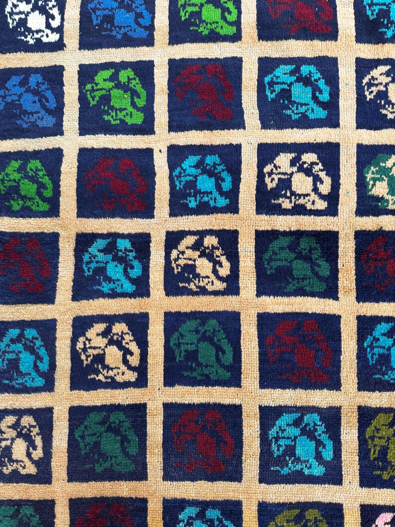 May include: A blue and beige rug with a repeating pattern of stylized trees in various colors, including green, red, and blue.