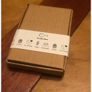 May include: A brown cardboard box with a white label that says "Thor Bari Khara" and has icons for unique, eco-friendly, vegan, handmade, and eco-friendly.