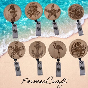 May include: Eight wooden badge reels with different ocean-themed designs, including a starfish, a seahorse, a jellyfish, an anchor, a flamingo, an octopus, and a coral reef. The reels are all brown and have a clear plastic clip.