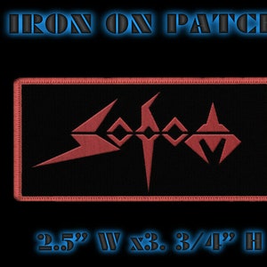 May include: Iron-on patch featuring the band logo "Slayer" in red embroidery on a black background. The patch is 2.5 inches wide by 3.75 inches high.