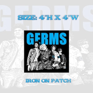 May include: Black and white iron-on patch featuring a band called "GERMS" with four band members. The patch is 4 inches high by 4 inches wide.