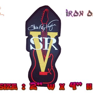 May include: An iron-on patch featuring a black guitar with a gold "V" and the text "SRV" in white. The guitar is outlined in red and the text "Stevie Ray Vaughan" is written in white above the "V". The patch is 2 inches wide and 4 inches high.