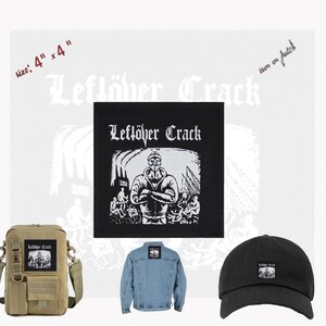 May include: Black and white iron-on patch featuring a band called "Leflöher Crack". The patch is 4 inches by 4 inches and shows a black and white illustration of a man with his arms crossed, standing in front of a group of people.