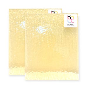 May include: Two rectangular, textured glass panels with a pale yellow hue. The panels have a bubbly, uneven surface. A white sticker with the text "b2 lc BINARI Glass Studio" is on the top right panel.