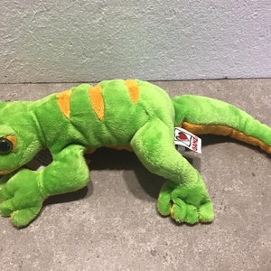 May include: Green and yellow plush lizard toy with a red heart tag that says "Ganz".