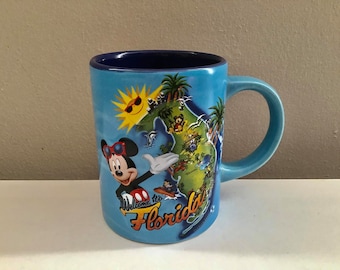 Taza de café azul de Jerry Leigh con Mickey Mouse de Disney, Bienvenido a Florida, Jerry Leigh