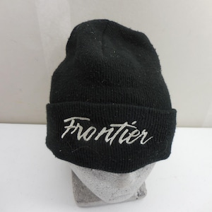 May include: Black knit beanie with the word "Frontier" embroidered in white script across the folded brim. The hat is made of a soft, textured material and is designed to be worn on the head.