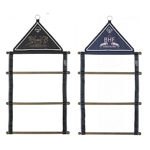 May include: Two black and blue horse tack drying racks with wooden dowels. The top of each rack has a triangular fabric panel with a horse logo and text. The left rack has a black panel with a gold horse logo and the text "MJH Team Brook Farm". The right rack has a blue panel with a white horse logo and the text "BHF Blinkers Hill Farm".