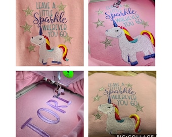 May include: A pink sweatshirt with a unicorn and the text "Leave a little sparkle wherever you go". The sweatshirt is being embroidered with the name "Tori" in purple thread.