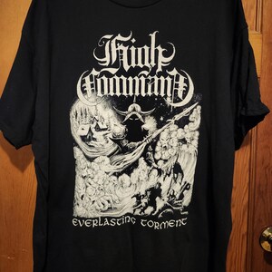 May include: Black t-shirt featuring a white graphic design with the words "Trinkt Command" in an ornate font above a detailed illustration. The words "everlasting torment" are below the illustration.