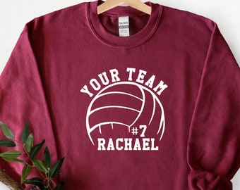 May include: Burgundy sweatshirt with a white volleyball graphic and the text "YOUR TEAM #7 RACHAEL".