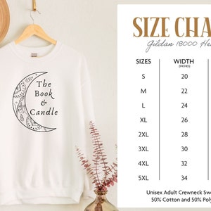 May include: White crewneck sweatshirt with a black crescent moon design and the text "The Book & Candle." The size chart shows measurements in inches for sizes S through 5XL. Made of 50% cotton and 50% polyester.