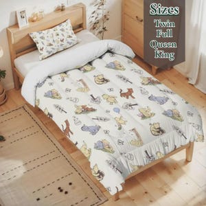 May include: A twin-sized bed with a white comforter and pillow set. The comforter features a repeating pattern of Winnie the Pooh and friends in various poses, with butterflies and flowers. The text "Sizes Twin Full Queen King" is visible.