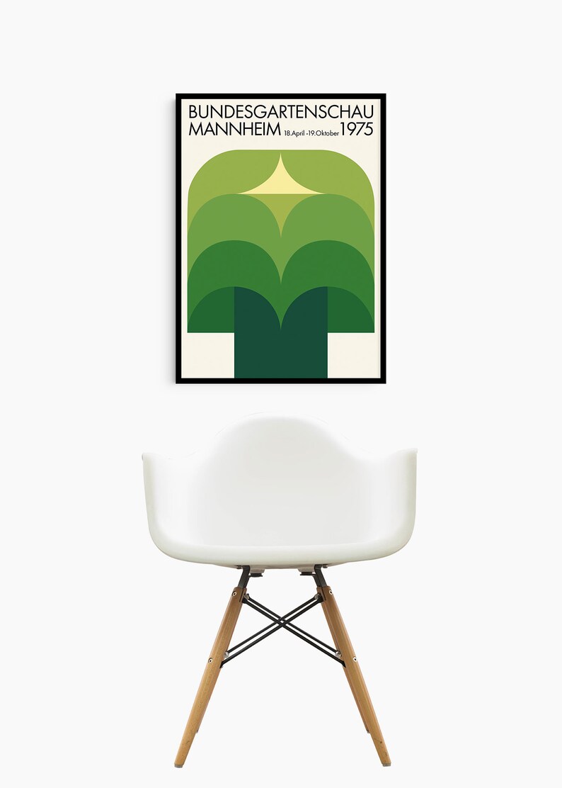 May include: A black framed poster with a green and yellow geometric design. The poster reads "Bundesgartenschau Mannheim 18.April-19.Oktober 1975".