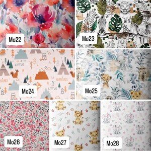 May include: A grid of seven fabric swatches labeled Mo22 through Mo28. Patterns include watercolor florals, jungle animals, woodland adventure motifs, tropical leaves, small red berries, cartoon lion cubs, and baby elephants with pink bows.