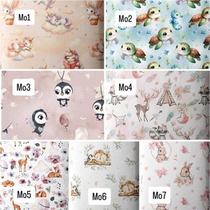 May include: A grid of seven fabric patterns labeled Mo1 through Mo7. Mo1 features unicorns on clouds. Mo2 shows sea turtles. Mo3 displays penguins and stars. Mo4 depicts woodland animals and teepees. Mo5 has deer and flowers. Mo6 shows lions. Mo7 features rabbits.
