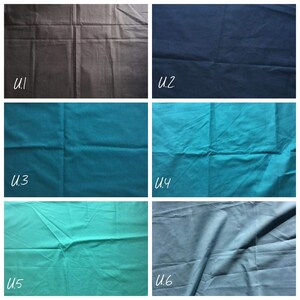 Op de afbeelding: Een raster van zes stofstalen gelabeld van U.1 tot U.6. De kleuren zijn donkergrijs, marineblauw, taling, turkoois, lichtgroen en leiblauw. Elke staal toont een effen, gekleurd textiel met zichtbare vouwen en kreukels over het hele oppervlak.