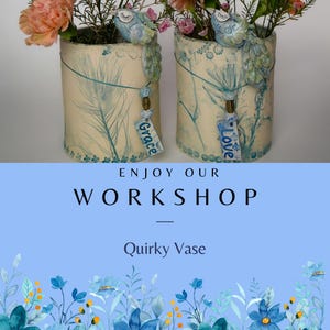 May include: Two cream-coloured cylindrical vases with blue feather and floral designs, each holding flowers. Decorative birds perch on the rims. One vase has a tag reading "Grace", the other "Love". The text "ENJOY OUR WORKSHOP" and "Quirky Vase" are also visible.