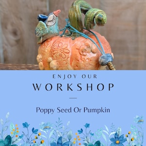 May include: A ceramic pumpkin with an orange body, green stem, and a blue bird perched on top. The pumpkin has a textured surface with floral designs. The text "ENJOY OUR WORKSHOP" and "Poppy Seed Or Pumpkin" are displayed below the pumpkin.