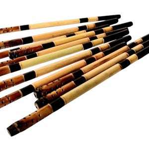 May include: A bundle of 12 bamboo incense sticks with black painted stripes. The sticks have holes for airflow and are ready to be used.