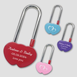 May include: Four heart-shaped padlocks in different colours: red, blue, purple, and pink. Each padlock has a silver metal loop and a red plastic latch. The red padlock has the text "Andrew & Bailey -05.09.2024- love you" engraved on it. The purple padlock has the text "Andrew & Bailey -08.09.2024- love you" engraved on it. The blue and pink padlocks have a white heart design.