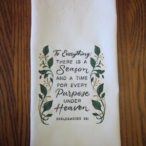 May include: White kitchen towel with green and gold embroidered leaves and the text "To Everything THERE IS A Season AND A TIME FOR EVERY Purpose UNDER Heaven ECCLESIASTES 3:1"