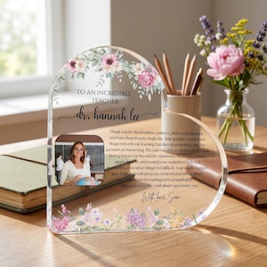 May include: A clear acrylic heart-shaped plaque with floral accents and the text "TO AN INCREDIBLE TEACHER dr. hannah lee." Includes a photo and a personalized message. A thoughtful gift for a teacher.