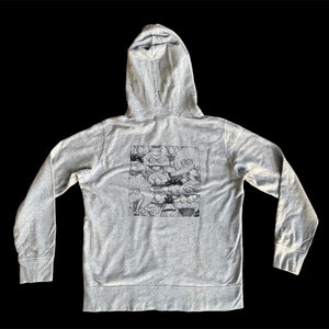 May include: A gray hooded sweatshirt with a black and white graphic print of Sesame Street characters on the back.