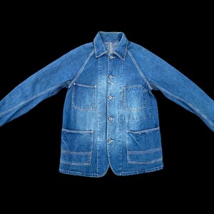 May include: A blue denim work jacket with multiple pockets and button closures.