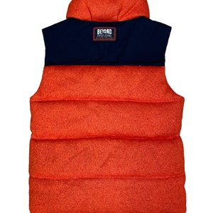 May include: Orange and navy blue puffer vest with a black label that reads "Beyond Evisu Jeans".