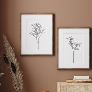 Gallery wall set above bed minimalist boho decor.  Eucalyptus wall hanging triptych line art.
