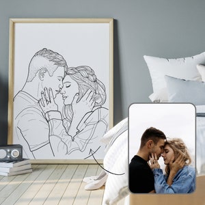 May include: Black and white line art illustration of a couple embracing. The man is on the left and the woman is on the right. They are both looking at each other with their eyes closed. The man has short hair and the woman has long hair. The illustration is in a simple style.