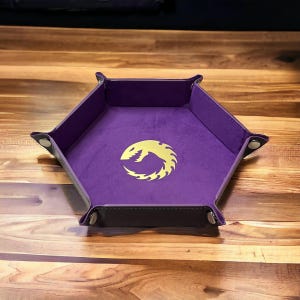 May include: Purple hexagonal dice rolling tray with a gold dragon logo in the center.