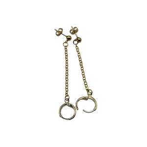 May include: A pair of gold chain earrings with a hoop at the end of each chain.