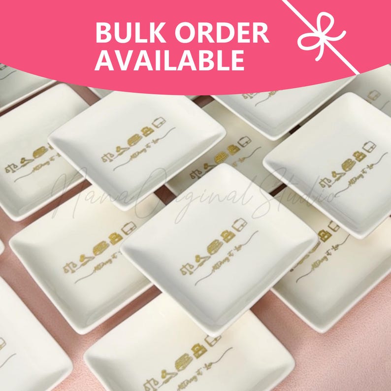 May include: A collection of white rectangular ceramic dishes featuring a gold-colored graphic of a scale of justice, a stack of books, and a briefcase, with the text "Attorney at Law" printed below the icons. A pink banner reads "BULK ORDER AVAILABLE."