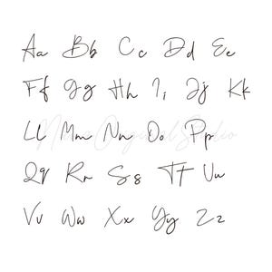 May include: A white background displays the alphabet in a handwritten cursive font. Each letter, from A to Z, is presented in both uppercase and lowercase forms. The elegant, flowing script is in black ink.