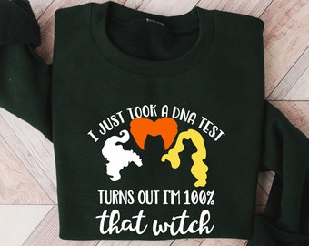 May include: A dark green sweatshirt with a white graphic that says "I just took a DNA test, turns out I'm 100% that witch". The graphic also includes a heart and three witch silhouettes.