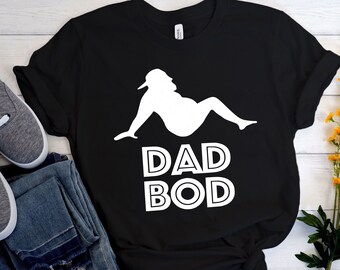 May include: Black t-shirt with a white silhouette of a person sitting down and the text "DAD BOD" in white.