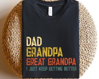 May include: Black t-shirt with a vintage-style graphic that reads "Dad Grandpa Great Grandpa I Just Keep Getting Better".