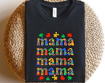 May include: Black t-shirt with the word "mama" repeated four times in a colorful puzzle piece design.