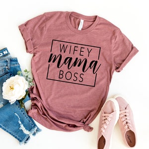 May include: A mauve t-shirt with the text "WIFEY mama BOSS" in a black box.