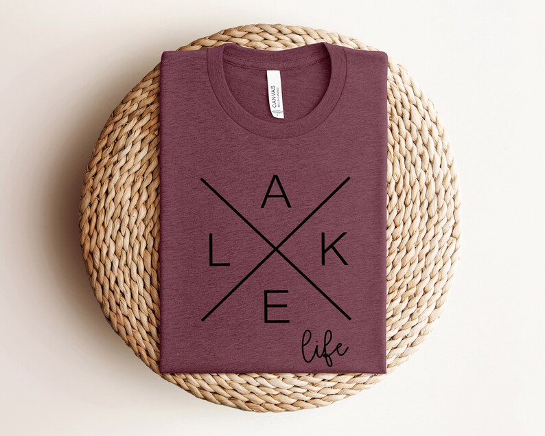 May include: A maroon t-shirt with a black graphic design that says "LAKE life" in a stylized font.
