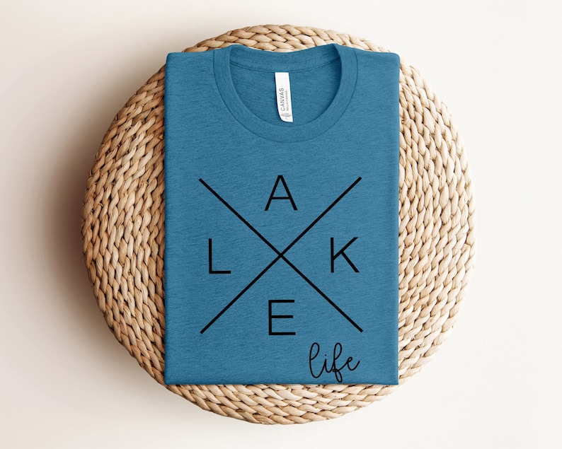 May include: A blue t-shirt with a black graphic design that says "LAKE life" with the letters "LAKE" forming a cross.