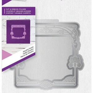 May include: A silver metal die-cutting and embossing folder with a decorative frame design. The folder is labelled "Moulins Frame" and is part of the Gemini brand by Crafter's Companion.