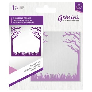 May include: A purple and white die-cutting embossing folder with a design of two trees with bare branches and grass. The text "Country Lane, Route de campagne, Camino rural" is printed on the folder. The folder is packaged in a clear plastic sleeve with a purple header that says "Gemini by Crafter's Companion".