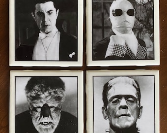 May include: Set of four black and white square coasters featuring classic horror movie characters. The coasters feature images of Dracula, the Creature from the Black Lagoon, Frankenstein's Monster, and the Mummy.