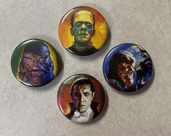 May include: Four round buttons with images of classic horror movie monsters. The buttons feature Frankenstein's monster, the Creature from the Black Lagoon, the Wolfman, and Dracula.