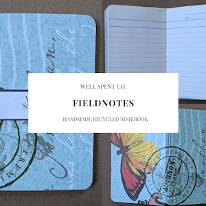 May include: A blue and white notebook with a butterfly design and the text "WELL SPENT CO. FIELDNOTES HANDMADE RECYCLED NOTEBOOK" on the front cover.